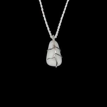 White sea glass with sterling silver embraced branches.  1/2" in size