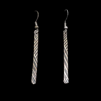 Pressed sterling silver dangle earrings finished with a dark patina wash