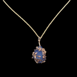 Cobalt sea glass wrapped in gold leaves necklace