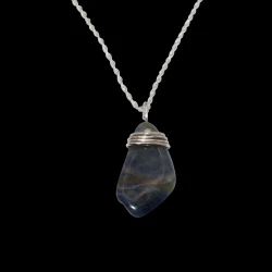 Necklace with a multi-colored polished stone from Newfoundland wrapped in sterling silver wire